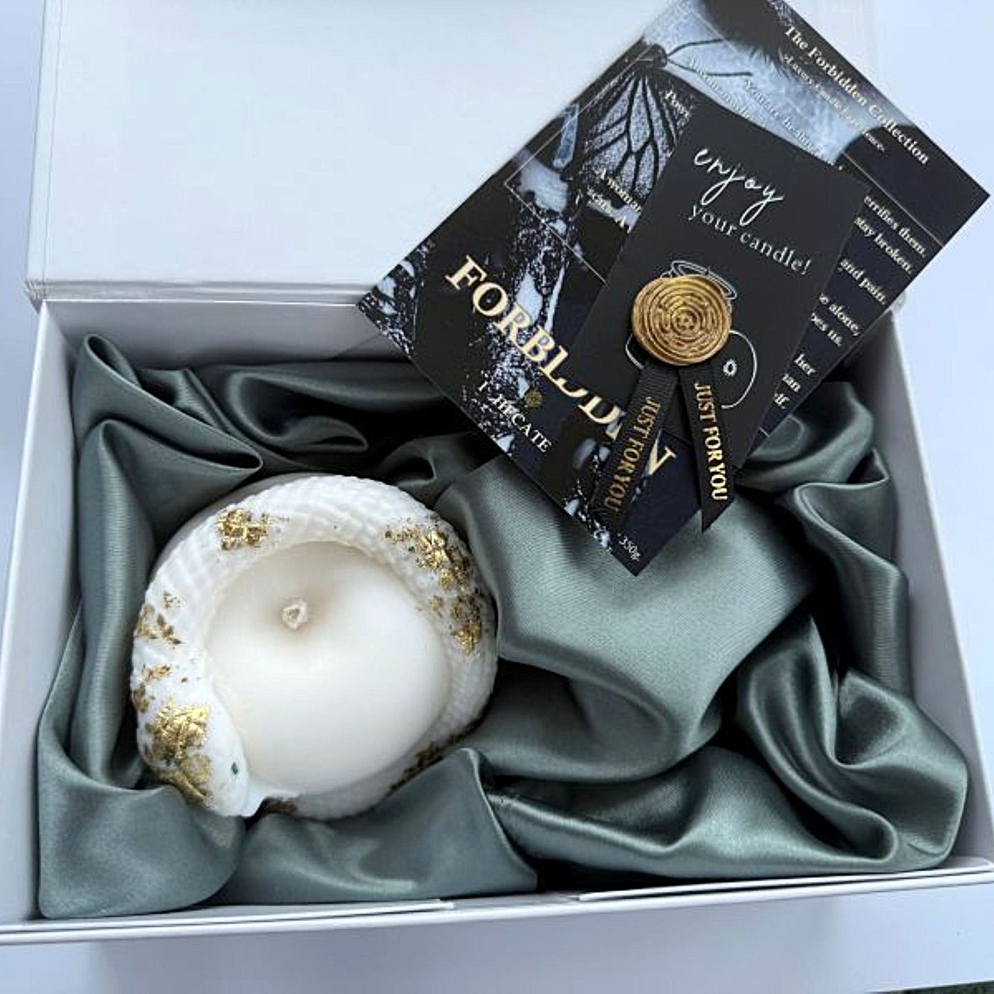 Candle in a box with decorative packaging and card
