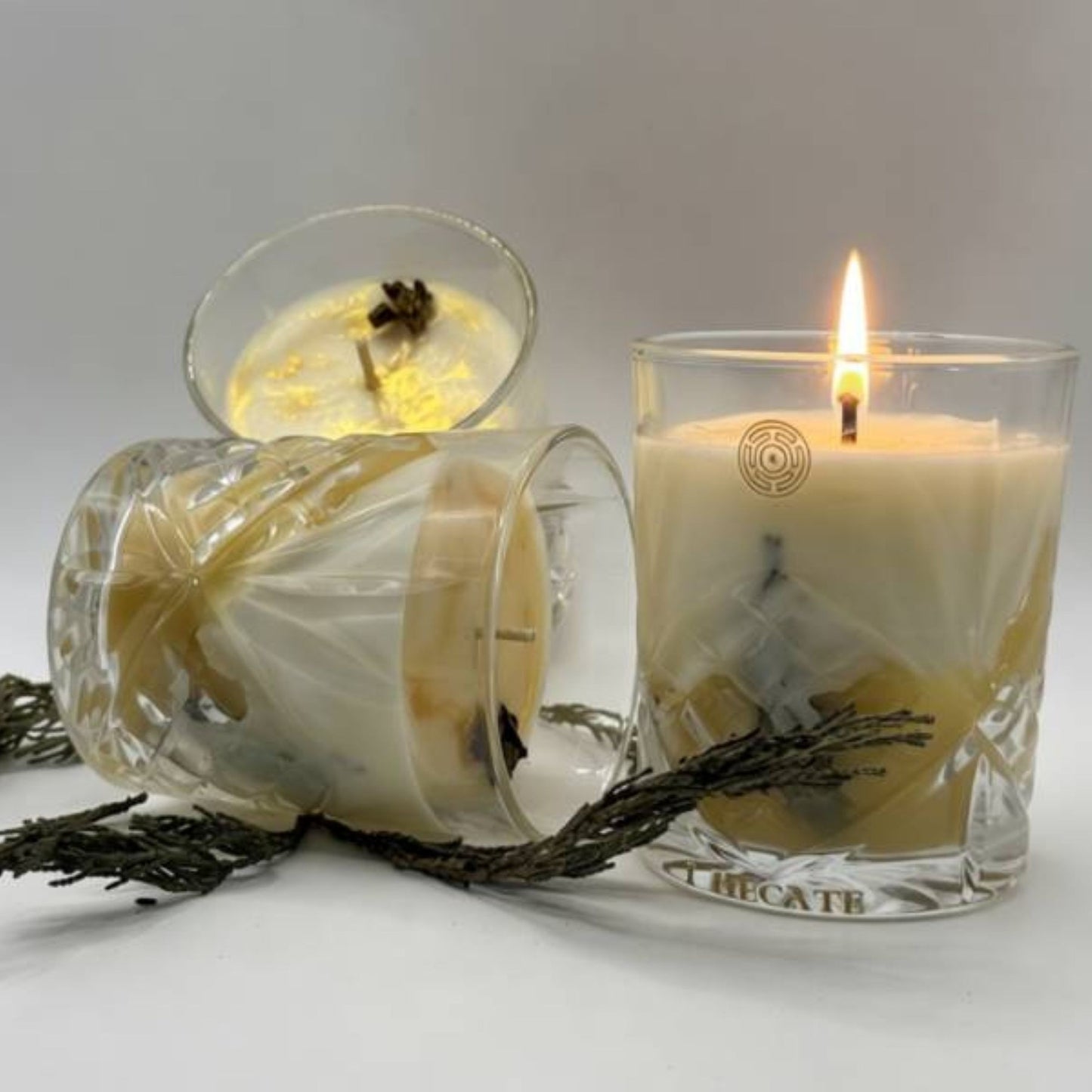 Handcrafted beeswax candle in crystal glass vessel with golden honeycomb details, luxury botanical ritual candle by I Hecate
