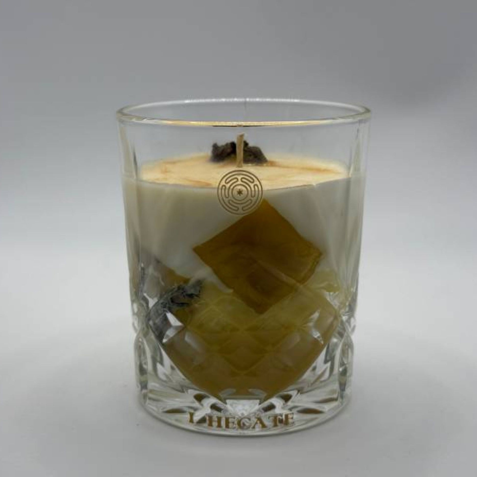 Handcrafted beeswax candle in crystal glass vessel with golden honeycomb details, luxury botanical ritual candle by I Hecate